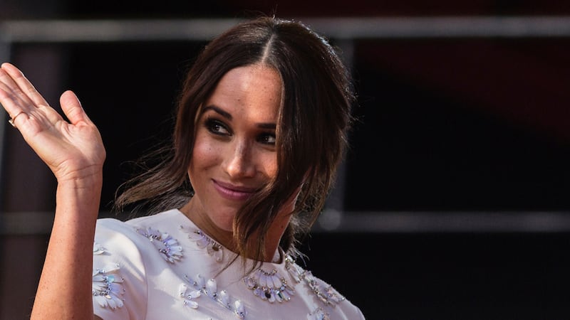 FILE - Meghan Markle, Duchess of Sussex, salutes during the Global Citizen festival, on Sept....