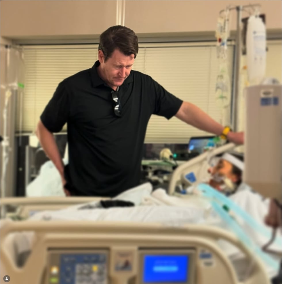 George Morgan stands over his sister, Brie Morgan Bauer's bed, as she undergoes a surgery in...